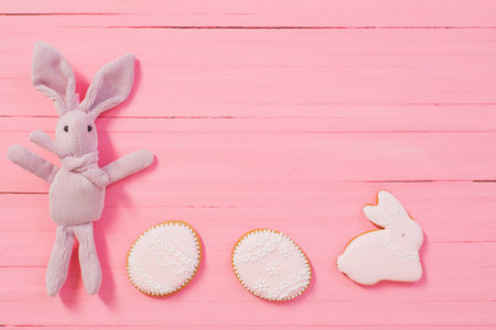 Easter decorations on pink wooden background