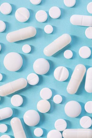 white pills on  blue backgroundの写真素材