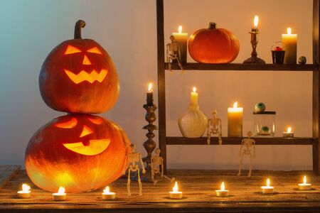 halloween pumpkins with candles on wooden tableの写真素材