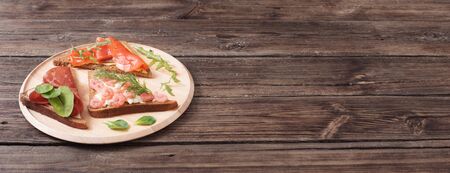 healthy sandwiches on wooden plate  on old wooden tableの写真素材