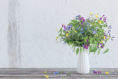 summer wild flowers in vase on white backgroundの写真素材
