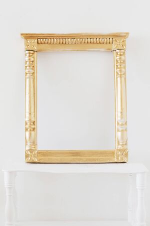 antique golden wooden frame on background white wallの写真素材