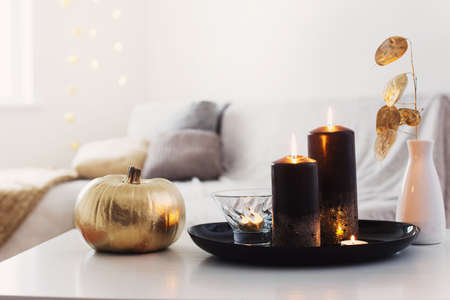 home decor with golden pumpkin and burning candlesの写真素材