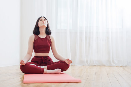 brunette girl doing yoga on floor at home