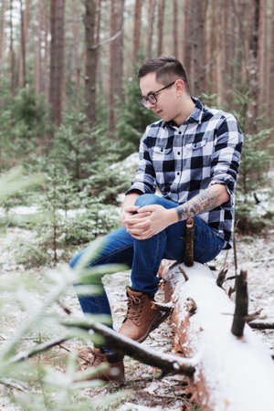 young man in winter forestの写真素材
