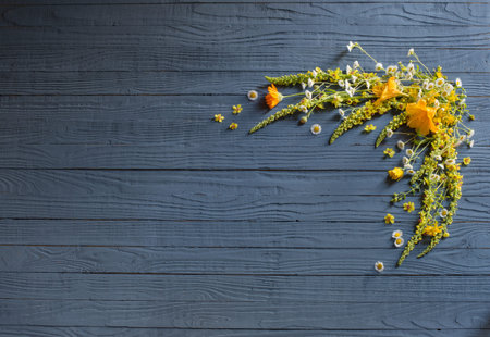 yellow summer flowers on blue wooden background