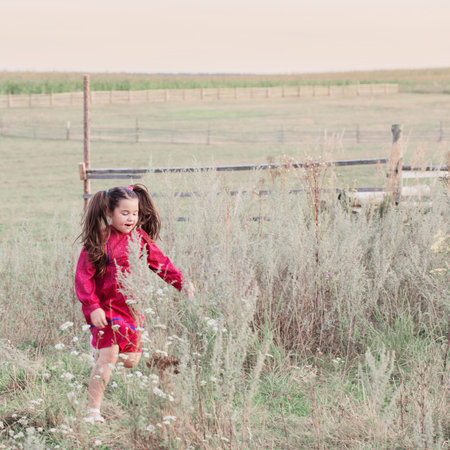 happy little girl in red dress outdoor