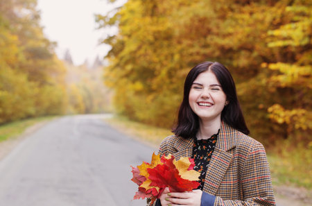 beautiful brunette girl in autumn park