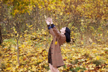 beautiful brunette girl in autumn park
