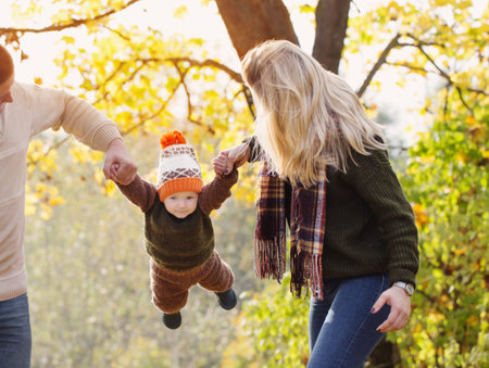 happy family with little baby in autumn park