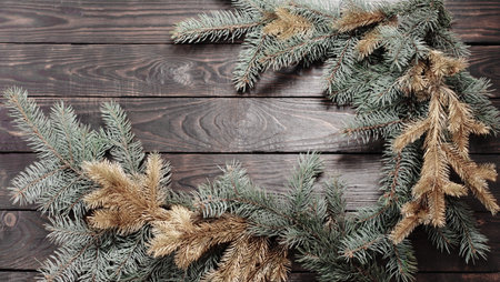 Christmas fir branches on old dark wooden background