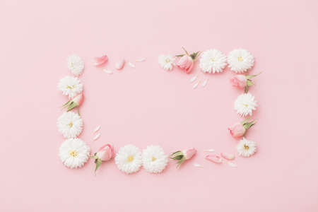 pink and white flowers on pink paper backgroundの写真素材