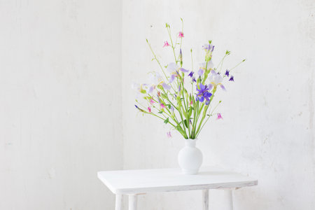 flowers in white vase in white vintage interiorの写真素材