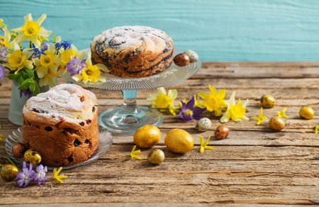 Easter cakes and eggs on blue wooden background
