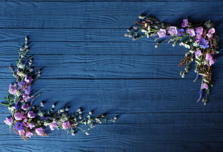 beautiful summer flowers on dark blue wooden backgroundの写真素材