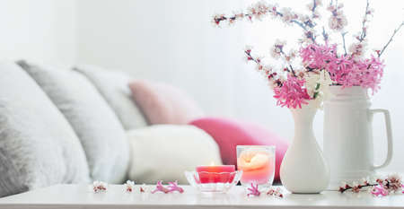 spring pink flowers in vase in white interiorの写真素材