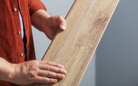 middle-aged man holding a laminate board in his handsの写真素材