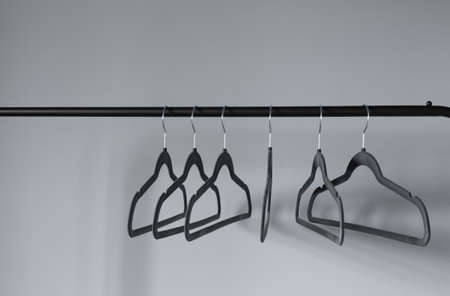 empty black clothes hanger on gray wall backgroundの写真素材