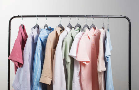 colored womens summer clothes on hanger on gray backgroundの写真素材