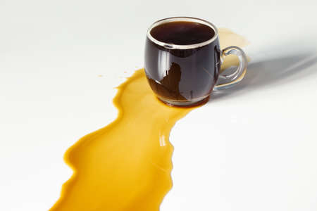 black coffee spilled on white tableの写真素材