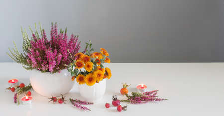 banner with yellow flowers with burning candles on gray backgroundの写真素材
