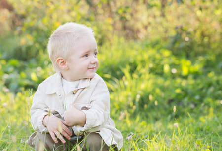 little happy blond boy outdoor on sunny summer dayの写真素材