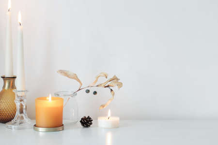 autumn home decorations with burning candlesの写真素材