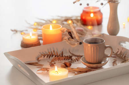 two cups of coffee and autumn decor on white wooden trayの写真素材