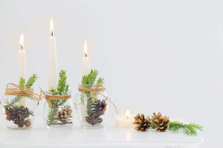 home christmas decor with burning candles in whte interiorの写真素材