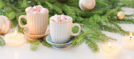 two cups of coffee with marshmallow and christmas fir branches