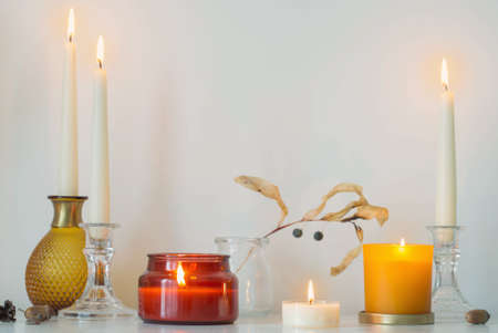 autumn home decorations with burning candlesの写真素材