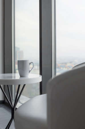 cup of tea on white table near windowの写真素材