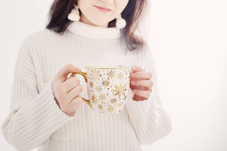 young woman with christmas cup on white background