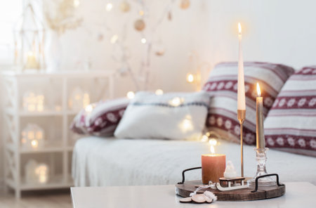 christmas home decorations with candles in white interiorの写真素材