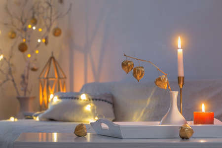 christmas home decorations with candles in white interiorの写真素材