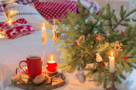 christmas home decorations with candles in red and white colorsの写真素材