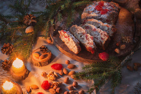 christmas baked goods with nuts, candles, fir branchsの写真素材