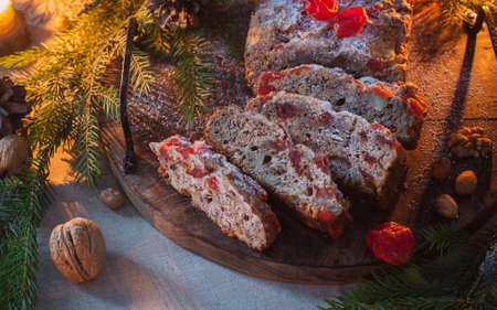 christmas baked goods with nuts, candles, fir branchsの写真素材