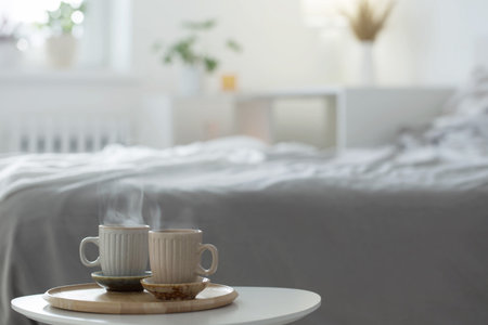 two cup of coffee on wooden tray in bedroomの写真素材