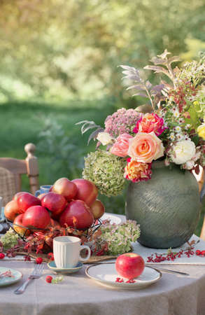 apple pie on laid table in garden on sunny dayの写真素材
