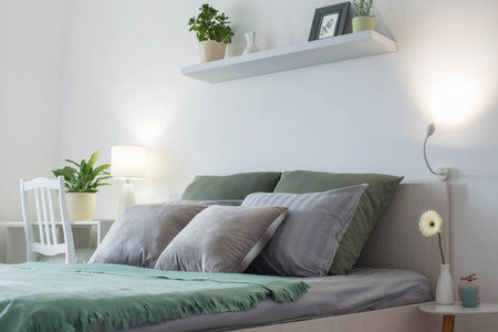 white bedroom with gray and green linens