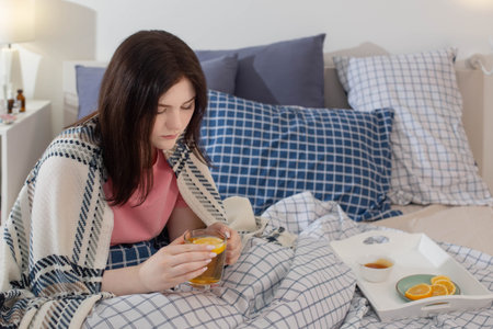 sick girl with tea in bed
