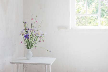 flowers in white vase in white vintage interiorの写真素材