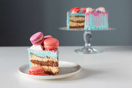 piece of cake with pink and blue decor on white tableの写真素材