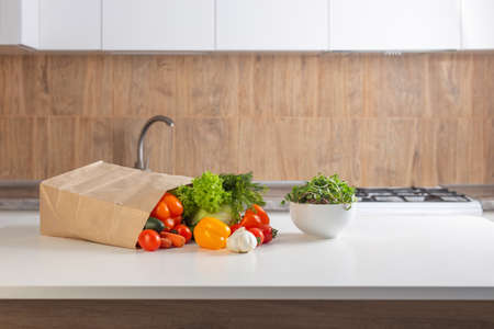 fresh vegetables on white table in kitchenの写真素材