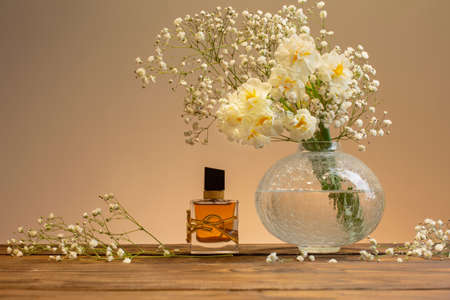 Krichev, Belarus, 16 February 2022: Yves Saint Laurent Libre Intense Eau de Parfum Fragrance with white flowers on wooden tableのeditorial素材