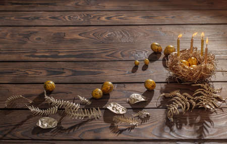 golden easter eggs on dark wooden backgroundの写真素材