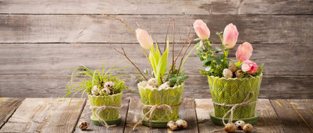 easter composition with eggs and flowers on wooden background