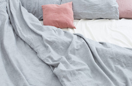 bed with gray and pink lines