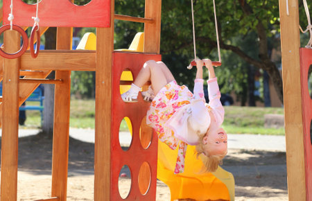 happy little girl on playgroundの写真素材